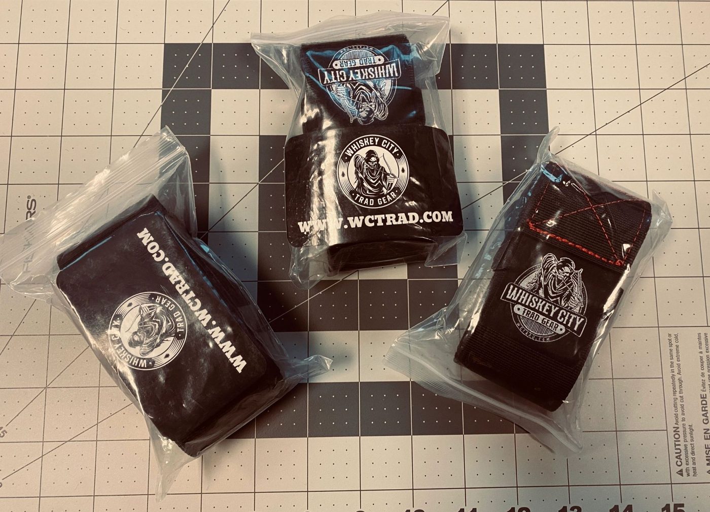 Whiskey City branded neoprene bottle holders in retail packaging